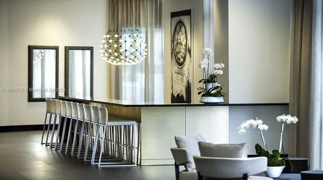 a kitchen with stainless steel appliances dining table and chairs