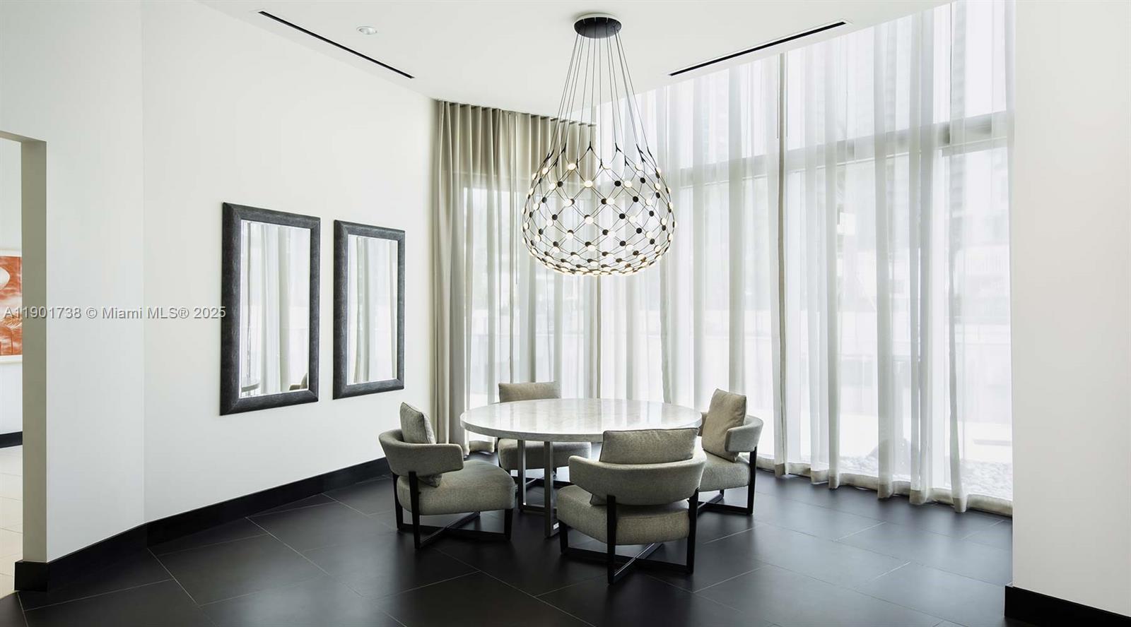 851 Northeast 1st Avenue, Unit 2106 Miami, FL 33132 - Photo 44 of 52 a dining room with wooden floor and furniture