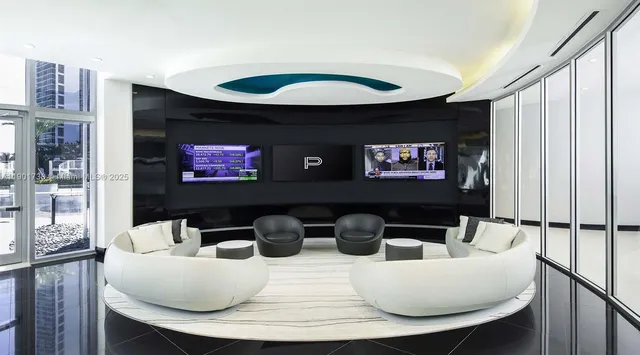 a living room with furniture and large windows