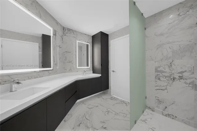 a bathroom with a double vanity sink a toilet and a mirror