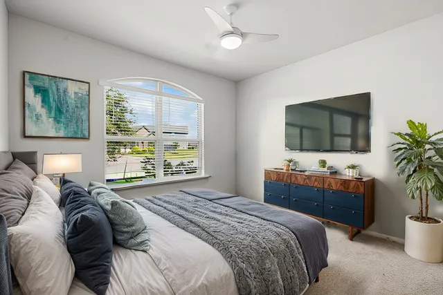 a bedroom with a bed and a flat screen tv