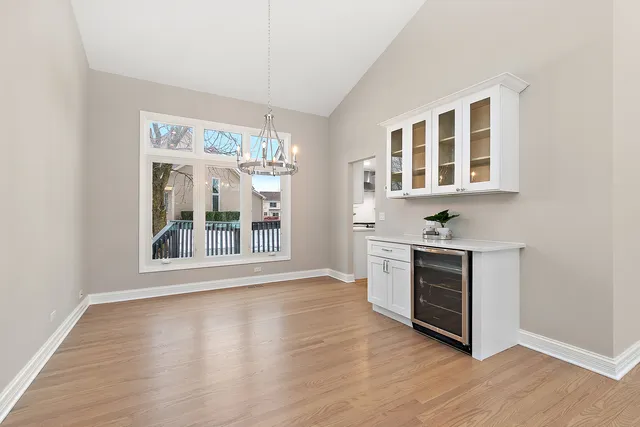 a large white kitchen with lots of counter top space and stainless steel appliances
