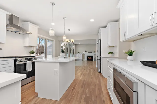 a kitchen with a sink a stove and cabinets
