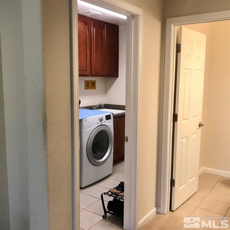 585 Connemaras Court Reno, NV 89521 - Photo 13 of 25 a utility room with sink dryer and washer