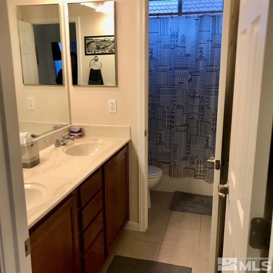 585 Connemaras Court Reno, NV 89521 - Photo 21 of 25 a bathroom with a sink and a mirror