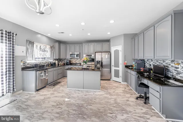 a kitchen with stainless steel appliances granite countertop a refrigerator stove sink and dishwasher