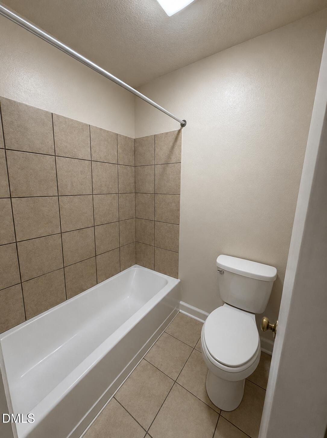 2506 Avent Ferry Road, Unit 101 Raleigh, NC 27606 - Photo 11 of 19 a bathroom with a toilet and bathtub