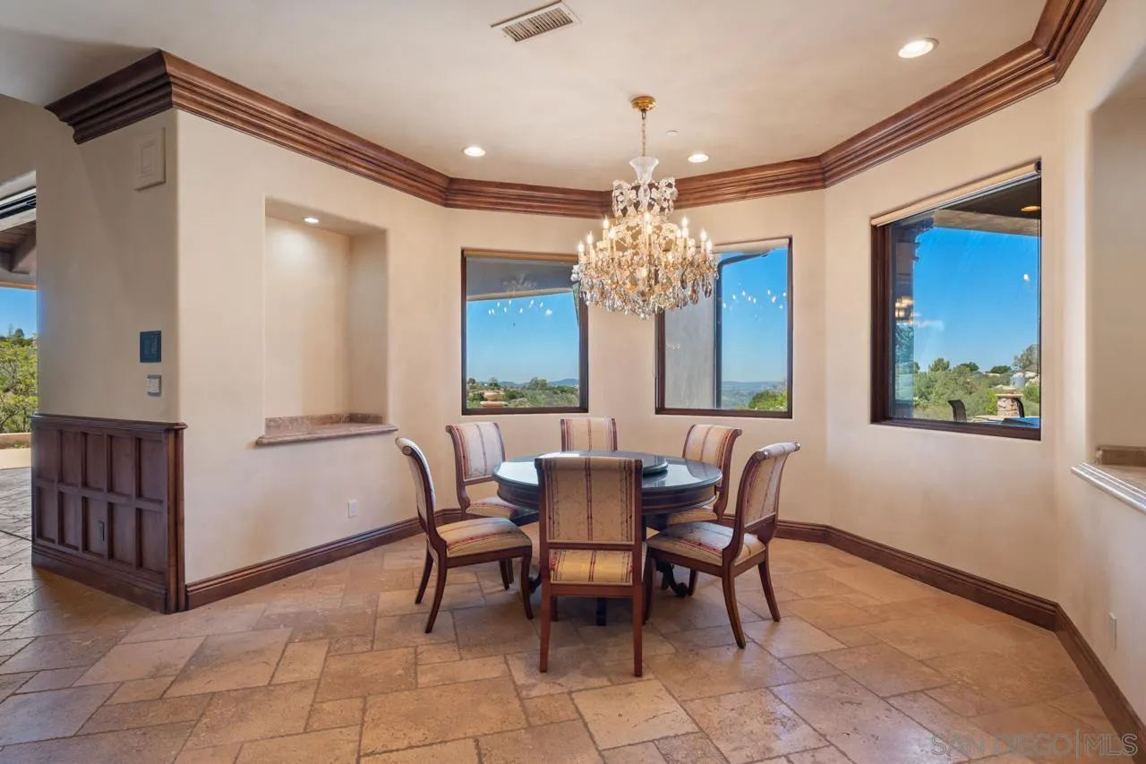 19612 Rangeland Road Ramona, CA 92065 - Photo 31 of 65 a view of a dining room with furniture and a chandelier