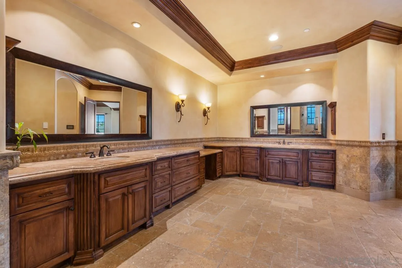 19612 Rangeland Road Ramona, CA 92065 - Photo 45 of 65 a large bathroom with a double vanity sink and a large mirror
