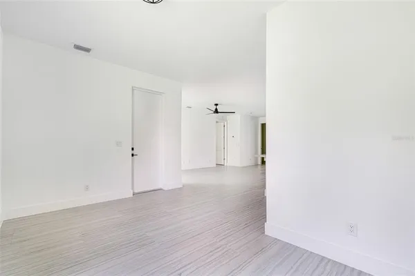 a view of a room with wooden floor