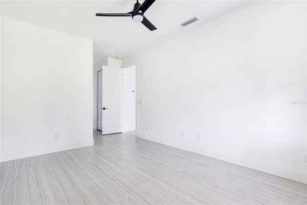 a view of an empty room with wooden floor
