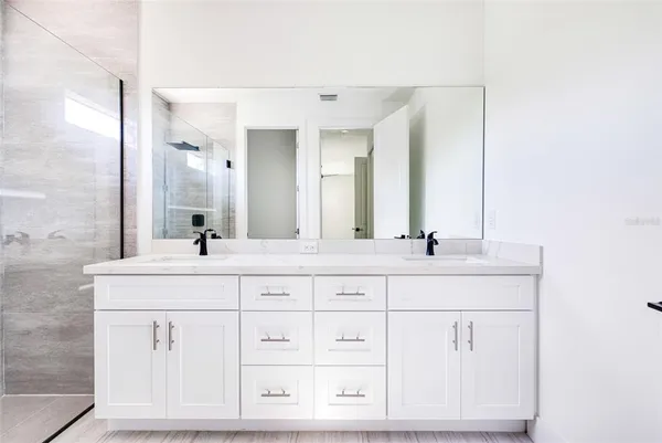 a bathroom with a sink vanity and mirror