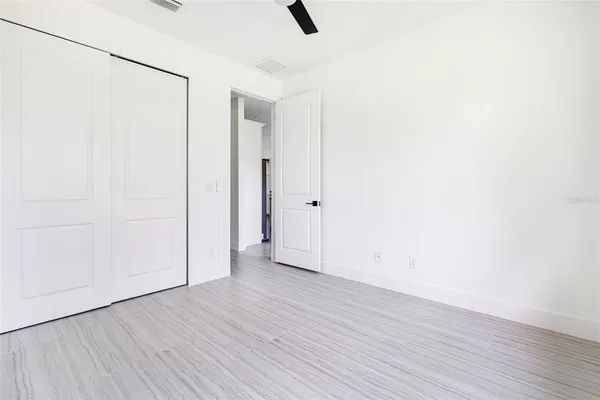 a view of an empty room with wooden floor