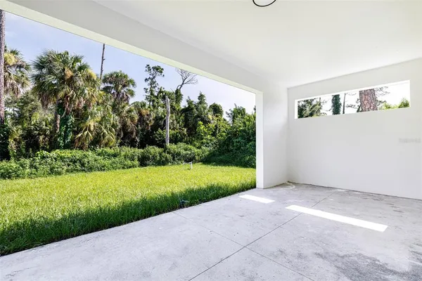 a front view of a house with a garden and plants