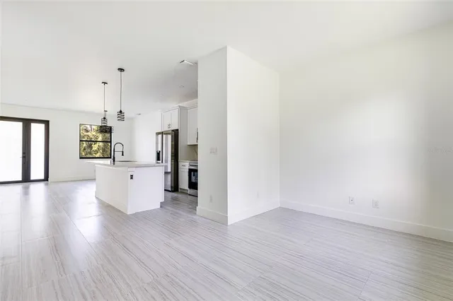 a view of a kitchen with wooden floor and a refrigerator