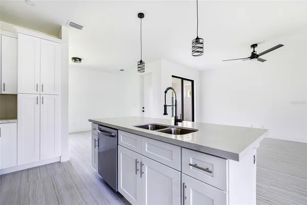 a kitchen with a sink and refrigerator