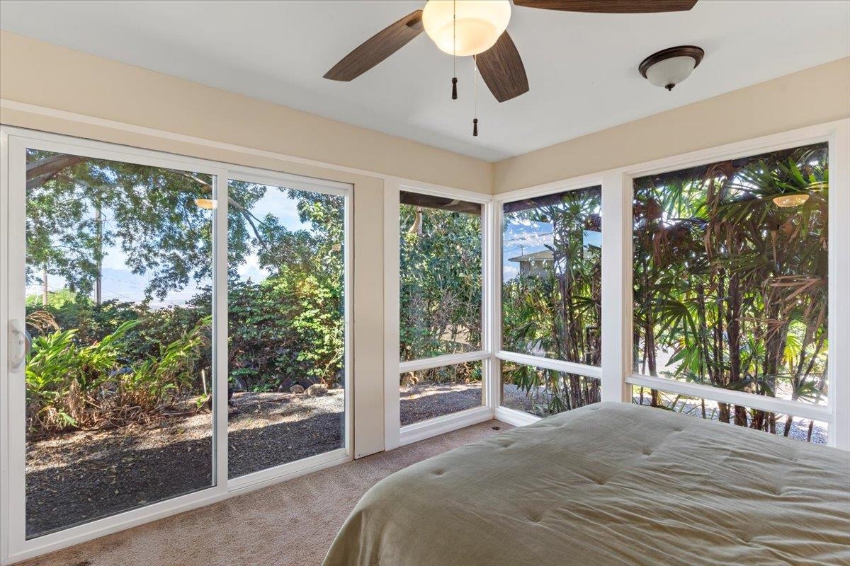 248 Piliwale Road Kula, HI 96790 - Photo 14 of 22 a view of a bedroom with balcony and floor to ceiling windows