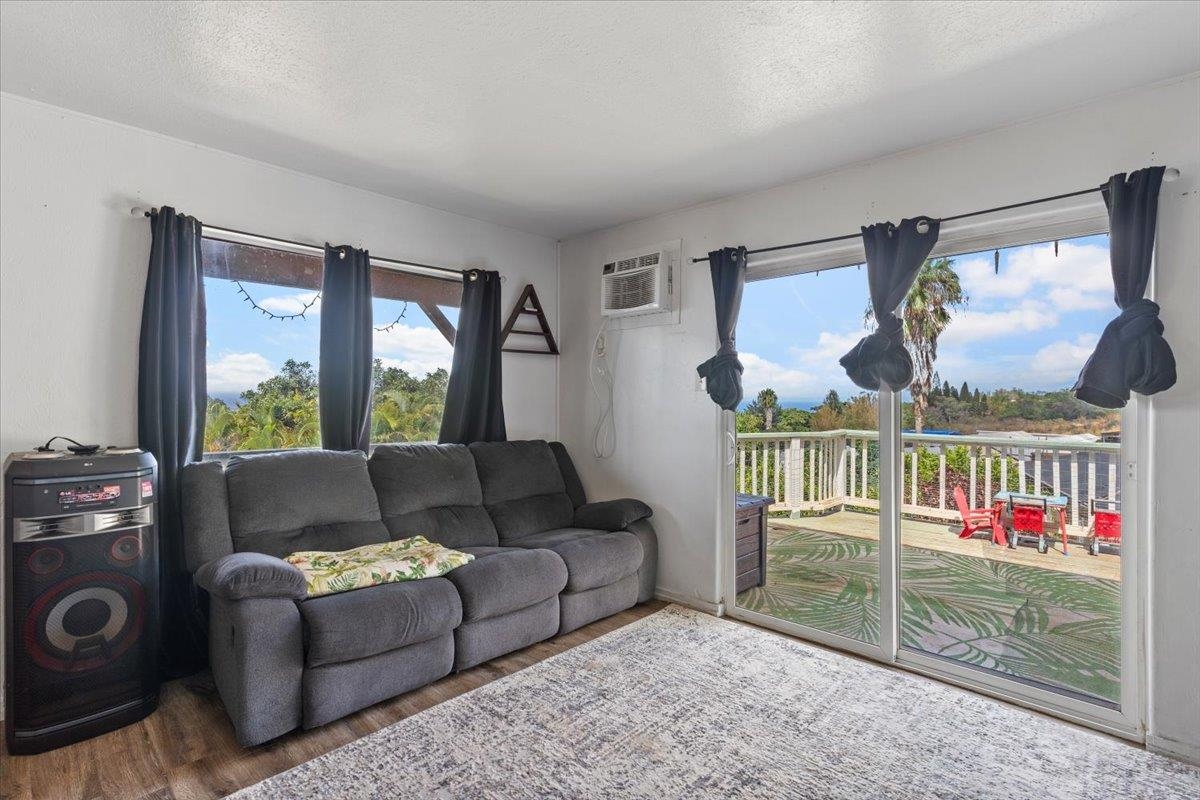 248 Piliwale Road Kula, HI 96790 - Photo 17 of 22 a living room with furniture and a floor to ceiling window