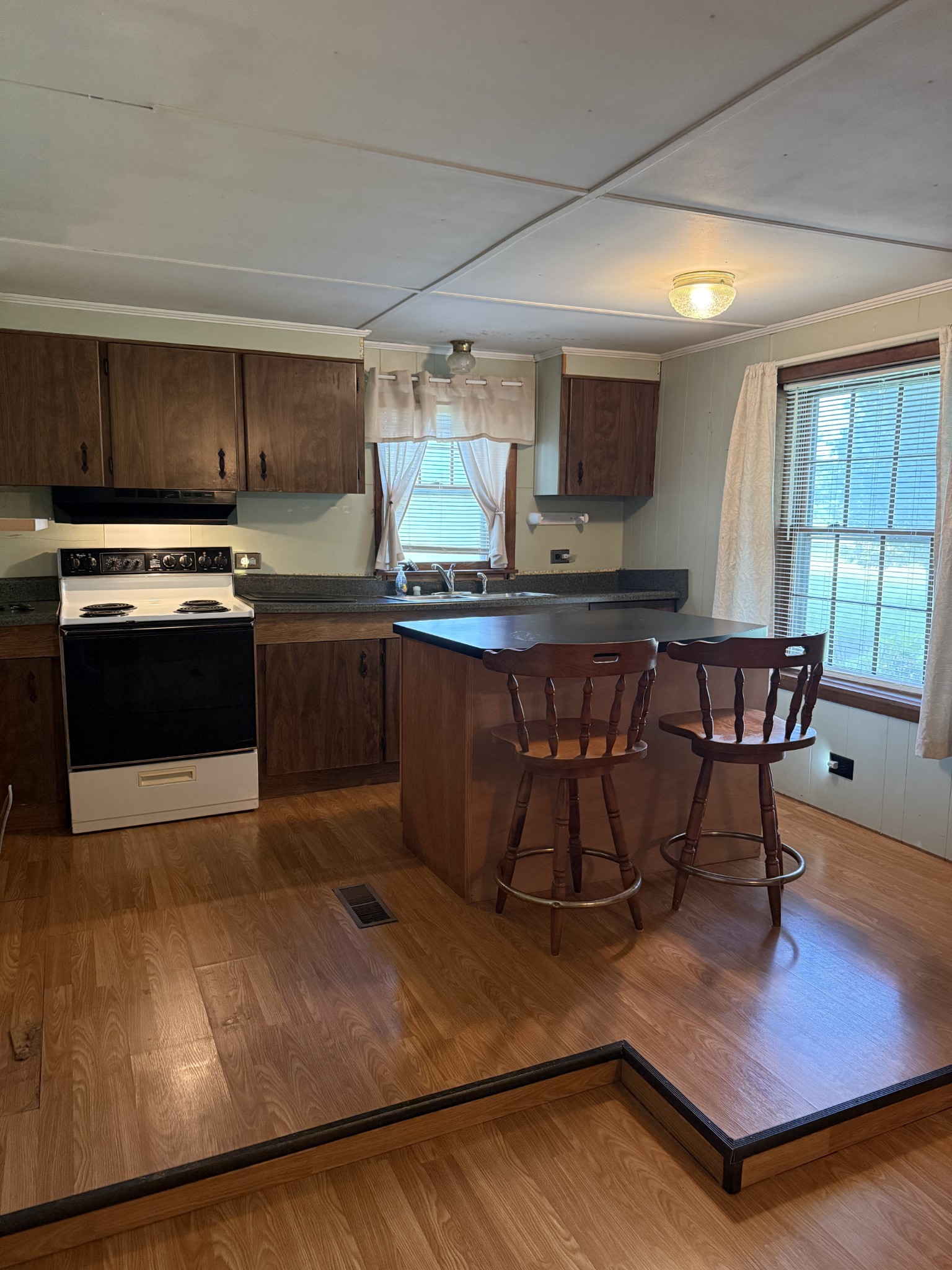 498 Ralph Broadrick Road Normandy, TN 37360 - Photo 8 of 17 a kitchen with stainless steel appliances granite countertop a stove a sink dishwasher a microwave oven and a dining table with wooden floor