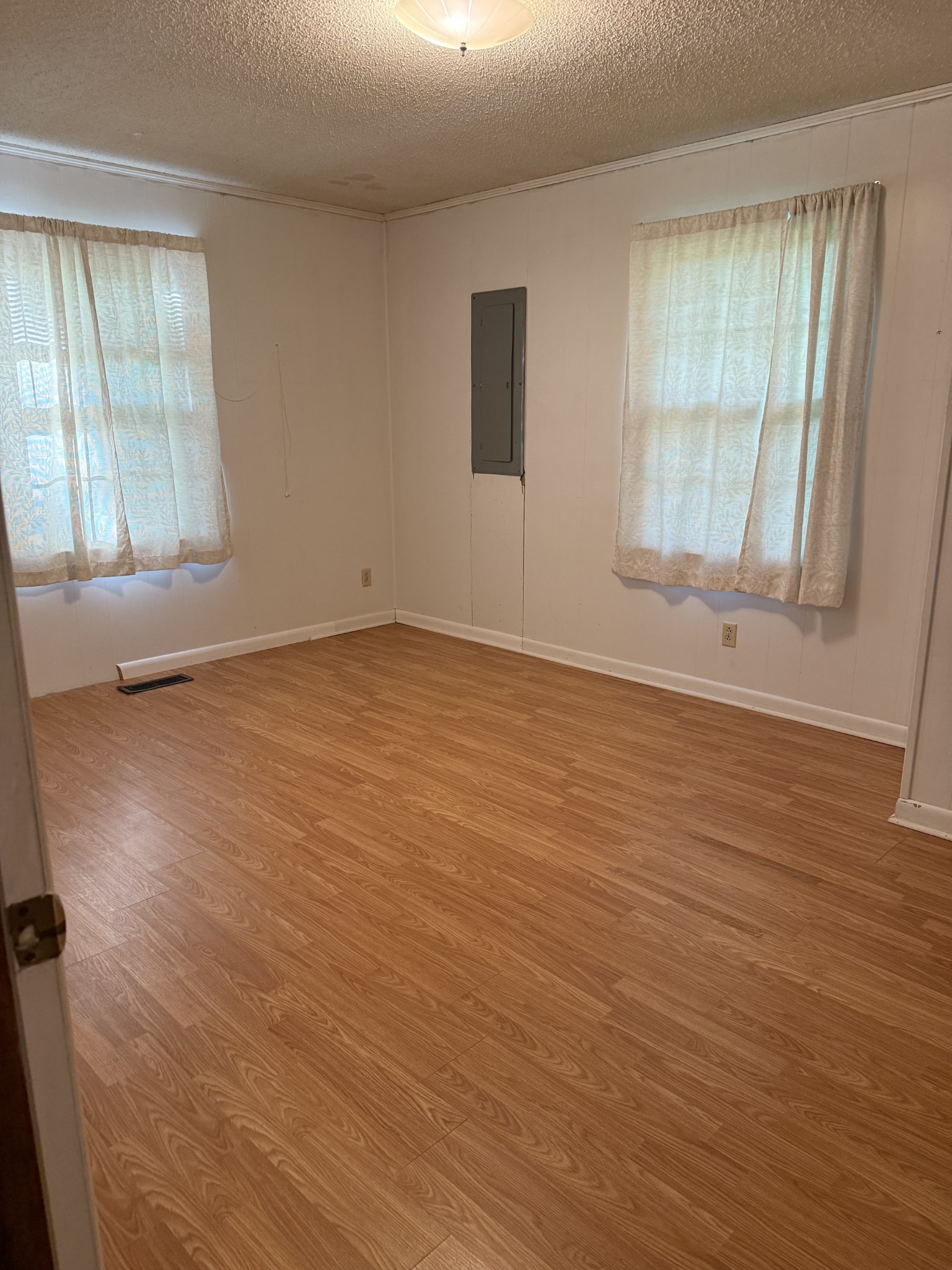 498 Ralph Broadrick Road Normandy, TN 37360 - Photo 10 of 17 an empty room with wooden floor and windows