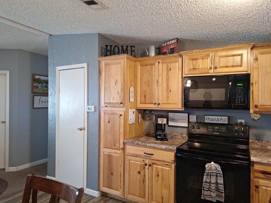 14899 Southwest 92nd Way Lake Butler, FL 32054 - Photo 13 of 39 a kitchen with stainless steel appliances a stove microwave and refrigerator