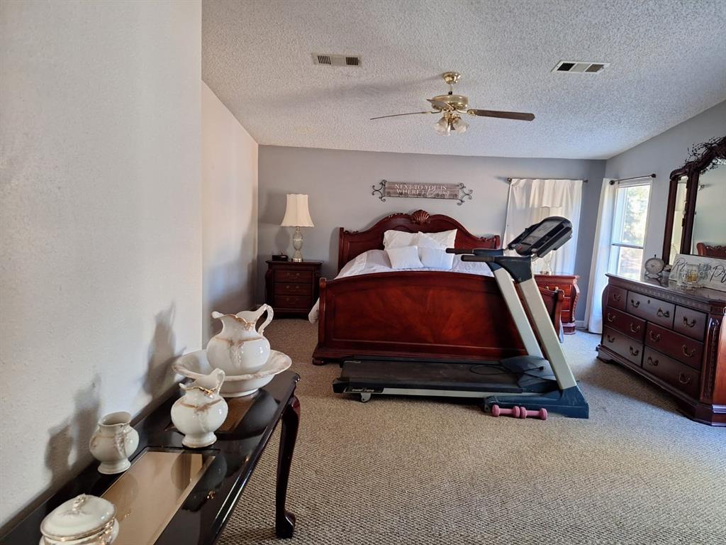 14899 Southwest 92nd Way Lake Butler, FL 32054 - Photo 18 of 39 a bedroom with a bed and a chandelier