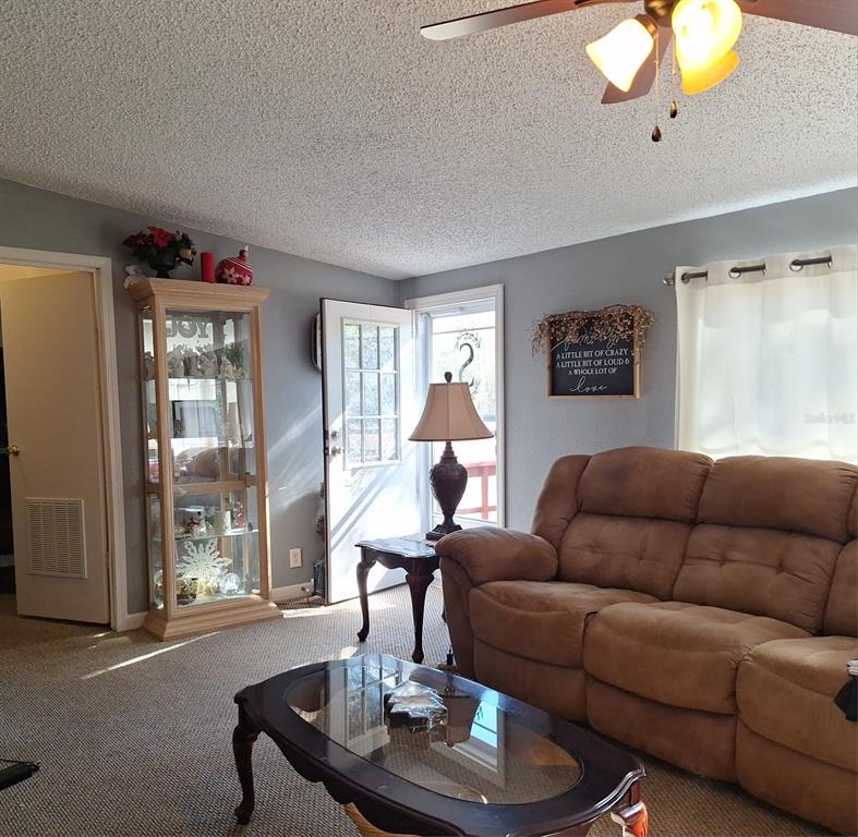14899 Southwest 92nd Way Lake Butler, FL 32054 - Photo 2 of 39 a living room with furniture and a large window