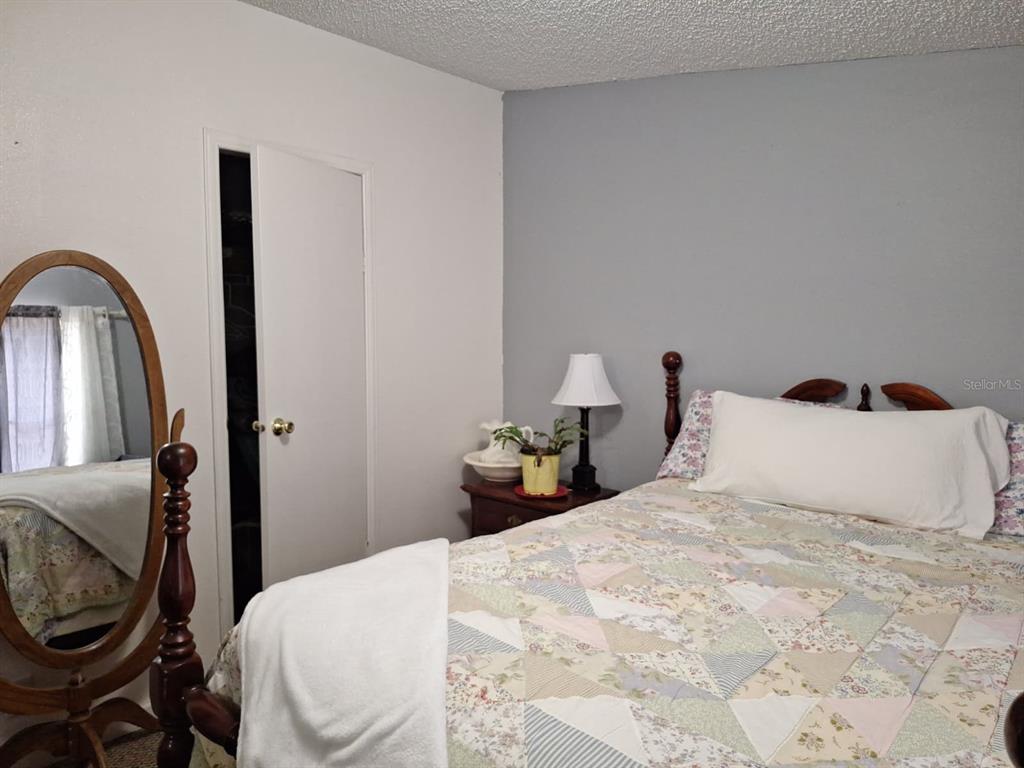 14899 Southwest 92nd Way Lake Butler, FL 32054 - Photo 25 of 39 a bedroom with a bed and wooden floor