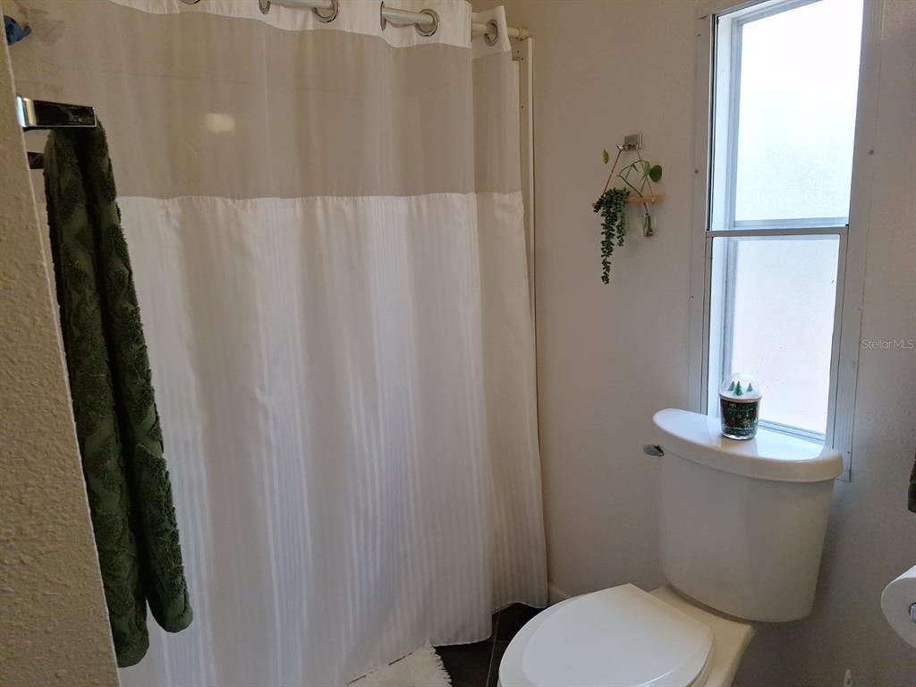 14899 Southwest 92nd Way Lake Butler, FL 32054 - Photo 29 of 39 a white toilet sitting next to a shower curtain