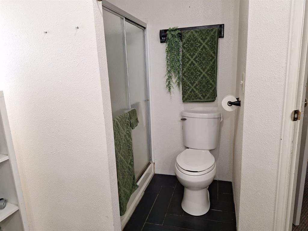 14899 Southwest 92nd Way Lake Butler, FL 32054 - Photo 32 of 39 a white toilet sitting in a bathroom next to a sink