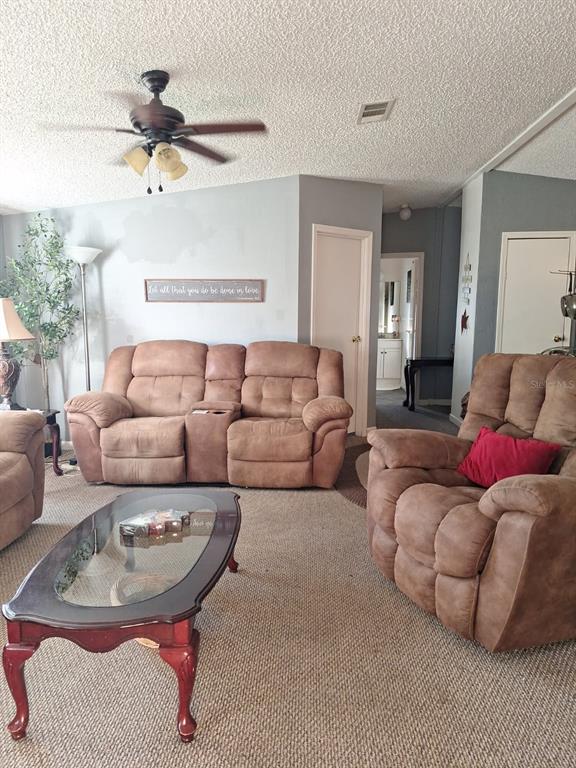 14899 Southwest 92nd Way Lake Butler, FL 32054 - Photo 4 of 39 a living room with furniture and a lamp