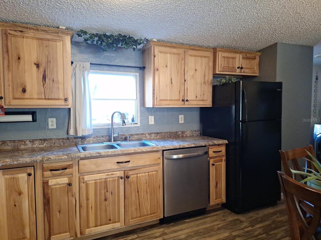 14899 Southwest 92nd Way Lake Butler, FL 32054 - Photo 9 of 39 a kitchen with stainless steel appliances granite countertop a refrigerator and a sink