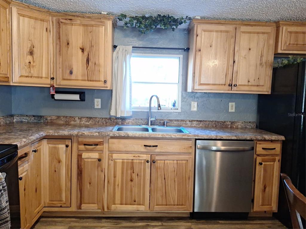14899 Southwest 92nd Way Lake Butler, FL 32054 - Photo 10 of 39 a kitchen with granite countertop a sink stove and cabinets