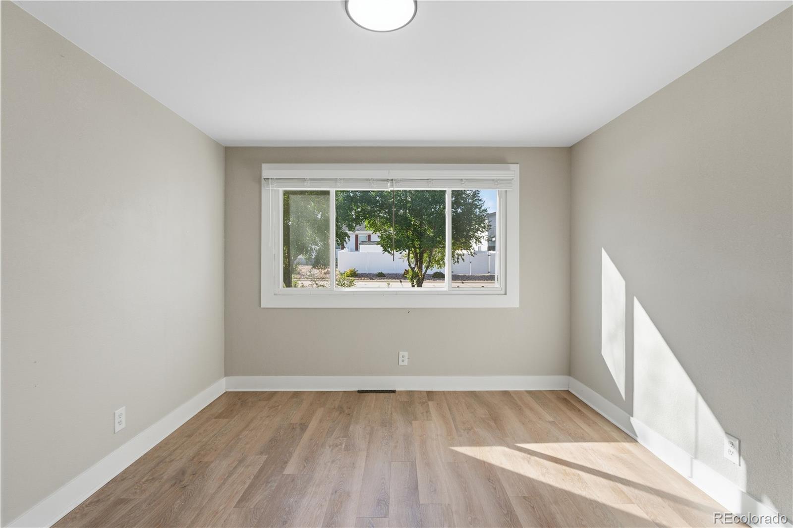 610 6th Street Bennett, CO 80102 - Photo 3 of 8 an empty room with a window