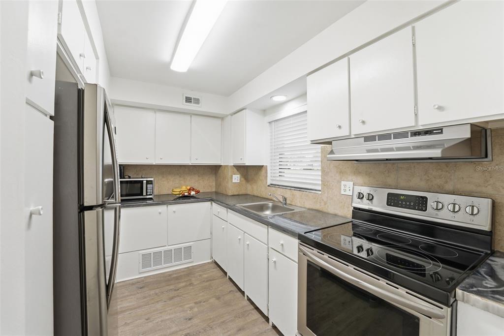 3900 Roxane Boulevard, Unit 10A Sarasota, FL 34235 - Photo 16 of 30 a kitchen with a sink appliances and cabinets