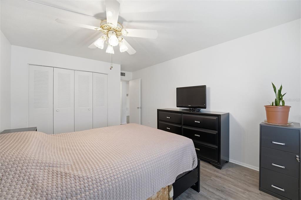 3900 Roxane Boulevard, Unit 10A Sarasota, FL 34235 - Photo 19 of 30 a bedroom with a bed and a flat tv screen on dresser