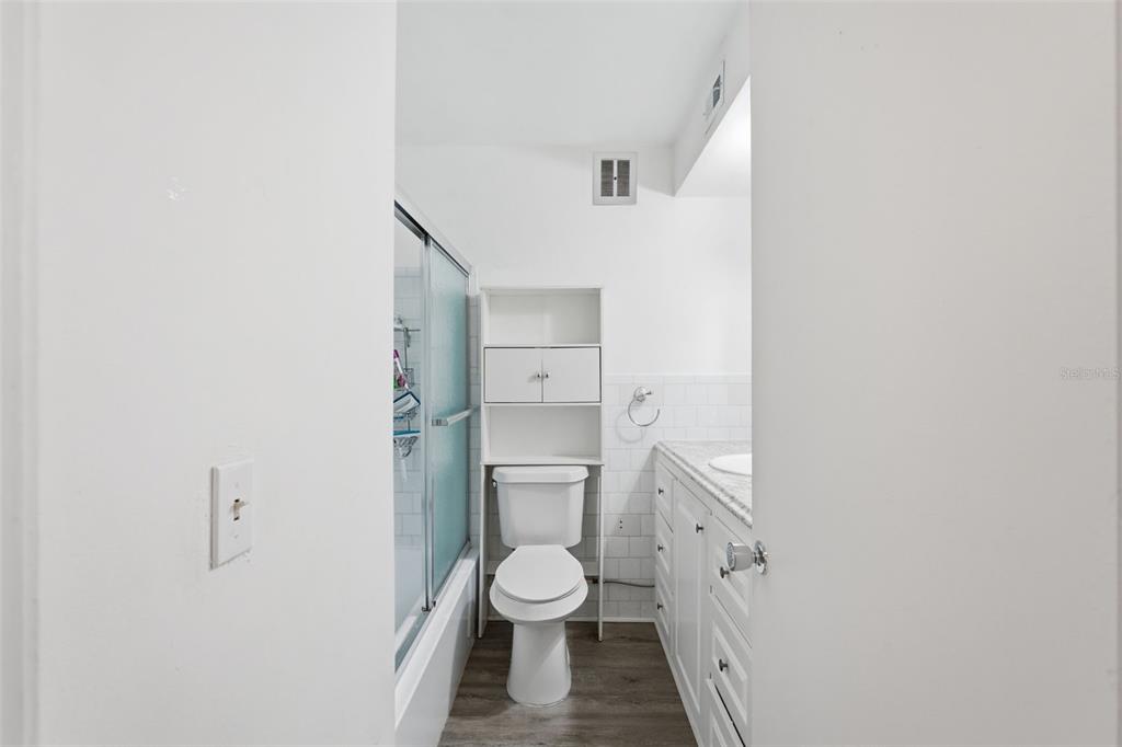 3900 Roxane Boulevard, Unit 10A Sarasota, FL 34235 - Photo 20 of 30 a bathroom with a granite countertop toilet a sink and a window