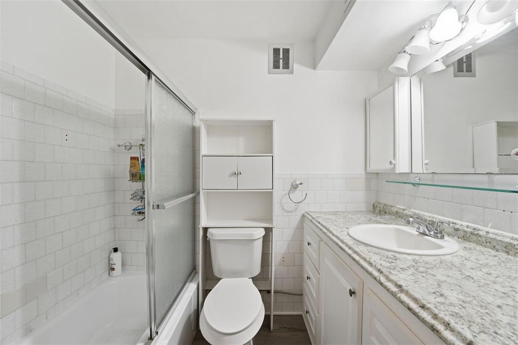 3900 Roxane Boulevard, Unit 10A Sarasota, FL 34235 - Photo 22 of 30 a bathroom with a granite countertop sink toilet and shower