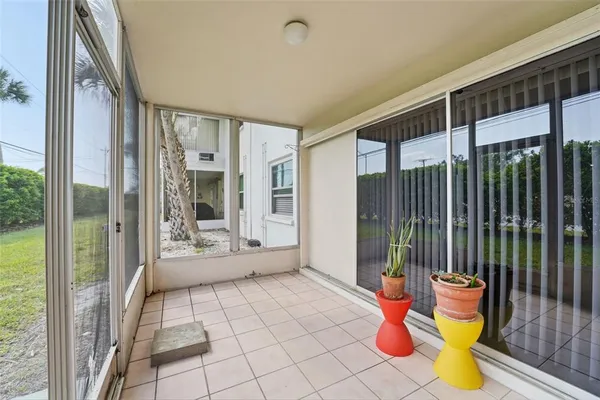 a view of an entryway with wooden floor and garden
