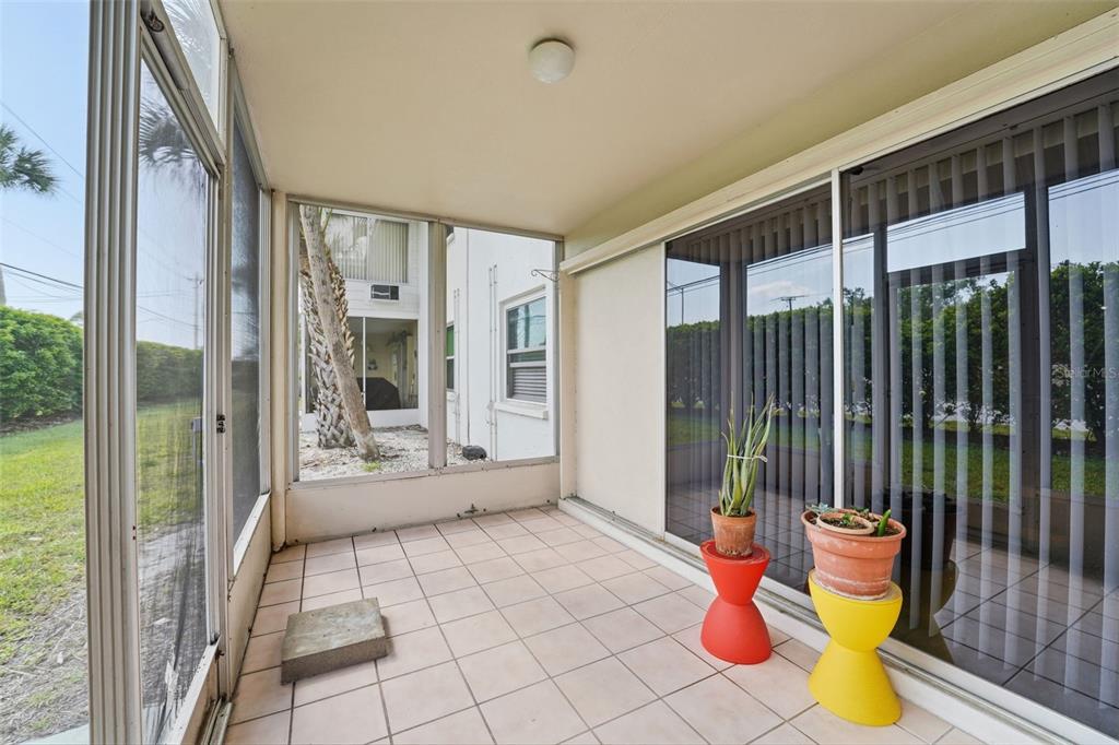 3900 Roxane Boulevard, Unit 10A Sarasota, FL 34235 - Photo 24 of 30 a view of an entryway with wooden floor and garden