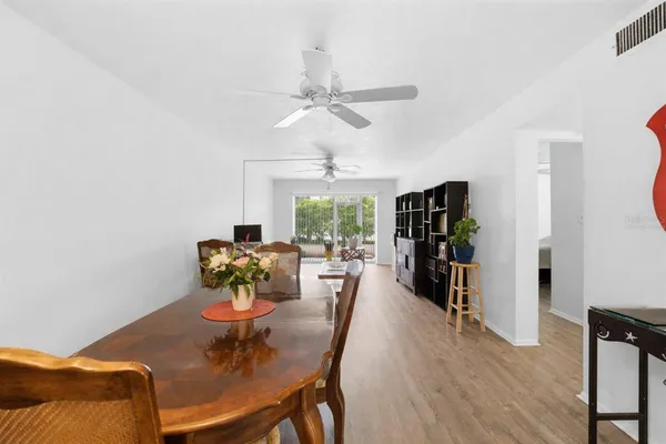 a dining room with furniture window and wooden floor