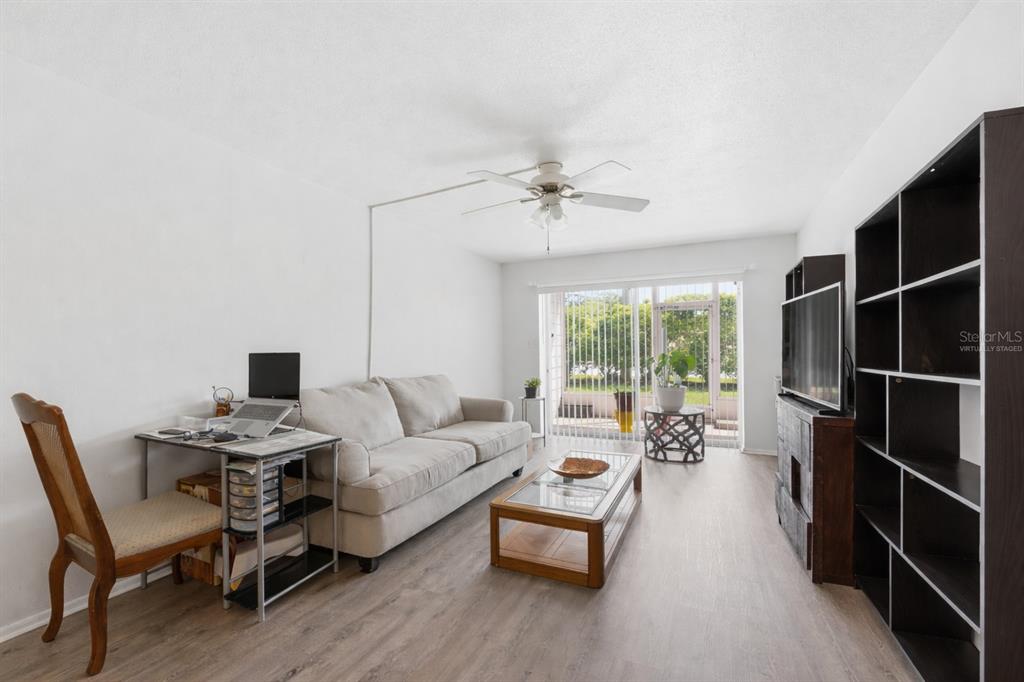 3900 Roxane Boulevard, Unit 10A Sarasota, FL 34235 - Photo 7 of 30 a living room with furniture and a large window