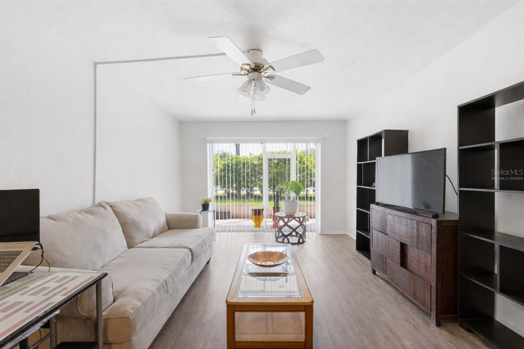 3900 Roxane Boulevard, Unit 10A Sarasota, FL 34235 - Photo 8 of 30 a living room with furniture and a flat screen tv