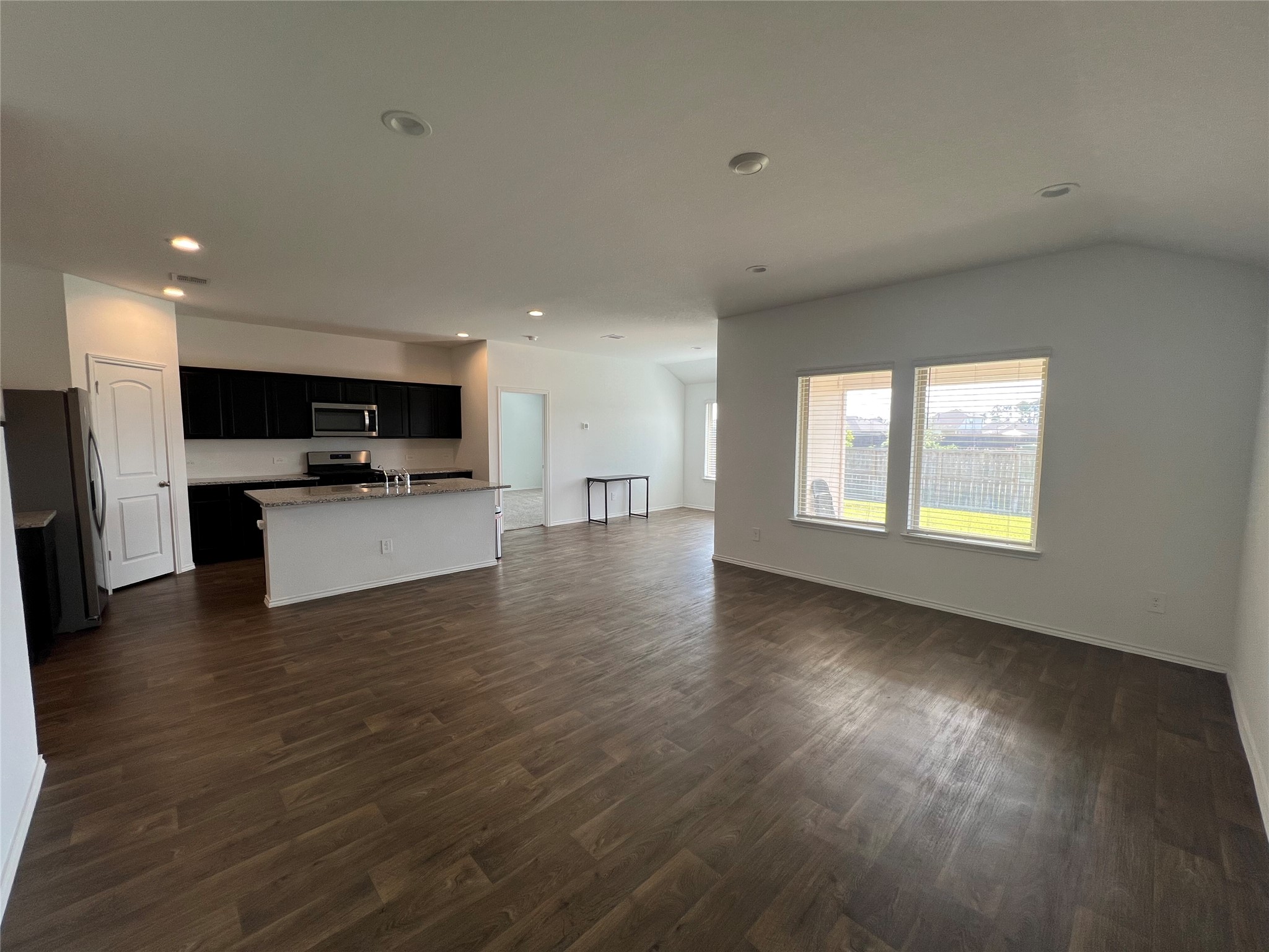 21354 Owl Road New Caney, TX 77357 - Photo 3 of 11 Living room over looking kitchen and dining room