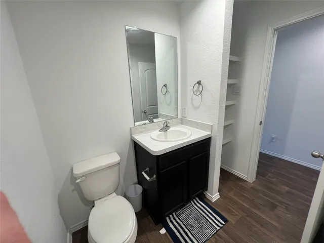 a bathroom with a sink toilet and mirror
