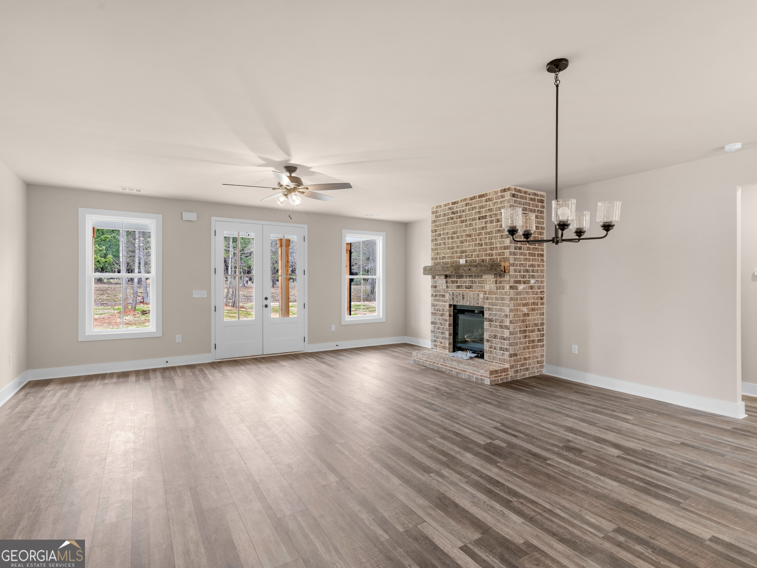 160 Loyd Road Mansfield, GA 30056 - Photo 20 of 53 a view of a livingroom with wooden floor and a ceiling fan