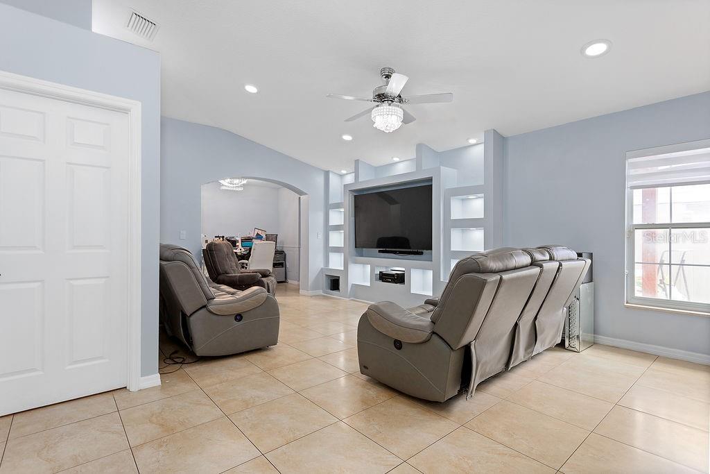 4907 Carlyle Road Tampa, FL 33615 - Photo 12 of 29 a living room with furniture and a flat screen tv