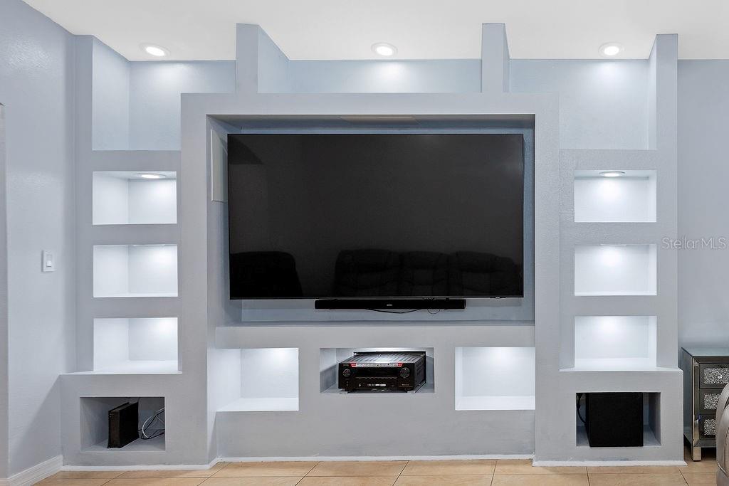 4907 Carlyle Road Tampa, FL 33615 - Photo 13 of 29 a living room with a flat screen tv and a fireplace