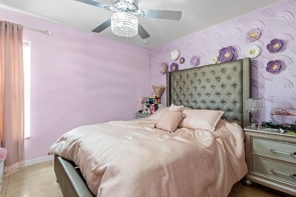 4907 Carlyle Road Tampa, FL 33615 - Photo 20 of 29 a bedroom with a bed and a wall painting