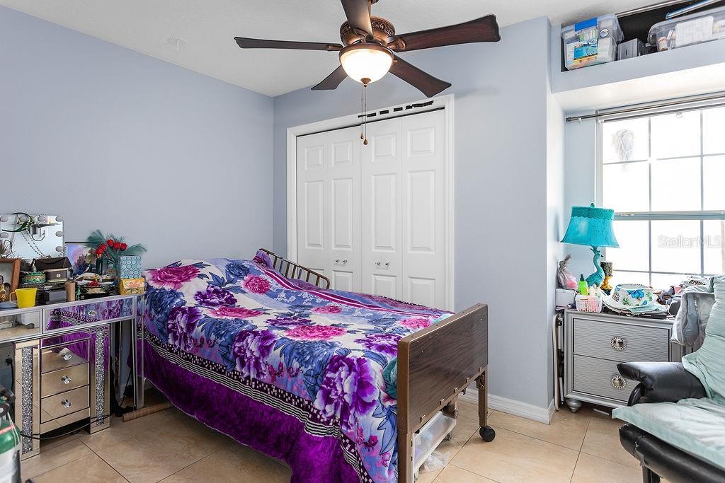 4907 Carlyle Road Tampa, FL 33615 - Photo 21 of 29 a bedroom with a bed and a chandelier